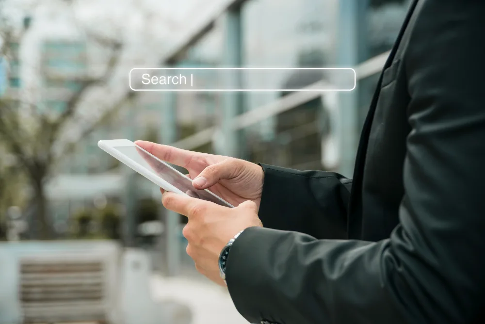 Business professional using a smartphone with a digital search bar overlay, depicting the evolving role of AI in SEO strategy refinement.