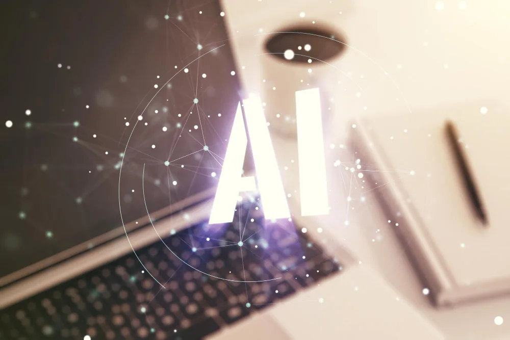 Symbolizing the intersection of technology and intelligence, this image depicts the conceptual representation of AI as an integral part of modern computing. A laptop sits open with a glowing AI symbol hovering above it, created through a multi-exposure effect that blends the tangible with the digital. This visual metaphor suggests the seamless integration of Google's AI tool with everyday technology, enhancing the user's ability to implement effective, data-driven decisions in their advertising strategies.