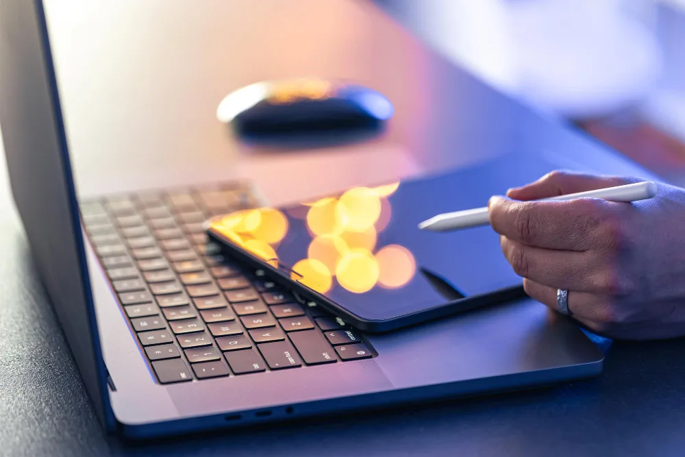 A female healthcare professional wearing a blue scrub and a stethoscope around her neck, smiling at the camera while holding a digital tablet, indicative of AI-enhanced healthcare content creation in the future.